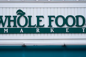 The Whole Foods Market logo is shown on the front of a store, July 14, 2021, Cambridge, Mass.