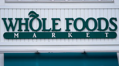 The Whole Foods Market logo is shown on the front of a store, July 14, 2021, Cambridge, Mass.