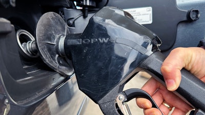 A customer pumps gas at a gas station in Mundelein, Ill., Feb. 8, 2024.