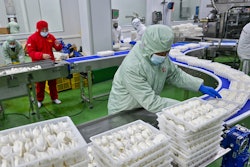 Workers pack dumplings at a production line at a food factory in Suqian city in east China's Jiangsu province on Jan. 21, 2025.