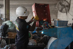Jesus Cuevas, a Petgas technician, puts plastic caps into a shredding machine inside a recycling center in Boca del Rio, Veracruz, Mexico, Jan. 4, 2025.
