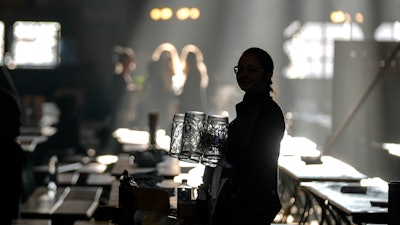 A waitress prepares beer mugs in the Augustiner marquee for the start of the 189th Oktoberfest beer festival, Munich, Germany, Sept. 21, 2024.