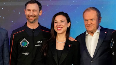 Polish astronaut Slawosz Uznanski-Wisniewski, left, with his wife Aleksandra Uznanska-Wisniewska and Poland Prime Minister Donald Tusk during a media event for the Ax-4 mission, Copernicus Science Center, Warsaw, Feb. 5, 2025.