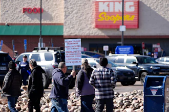 Workers walk a picket line outside a Denver King Soopers store, Feb. 6, 2025.