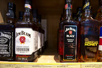 In this July 7, 2018, file photo, whiskeys distilled and bottled in the U.S. are displayed for sale in a grocery store in Beijing.