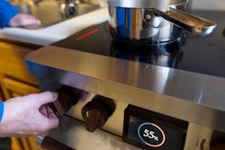 Ed Yaker boils water on a Copper stove, an electric induction stove, Feb. 10, 2025, New York.