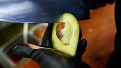 A worker cuts a avocado at Birrieria Chalio Mexican Restaurant, Fort Worth, Texas, Feb. 13, 2025.