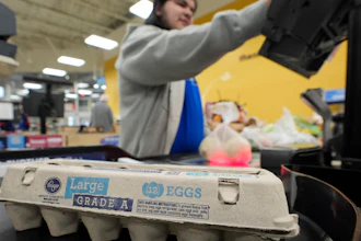 Cashier Josh Jimenez rings up egg for sale at a Dallas grocery store, Feb. 7, 2025.