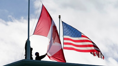 Washington State Park workers put up a new Canadian flag atop the Peace Arch in Peace Arch Historical State Park, Nov. 8, 2021, Blaine, Wash.