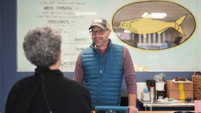Bryan Szeliga, owner of Fishtown Seafood, speaks with a customer at his shop in Haddonfield, N.J., March 6, 2025.