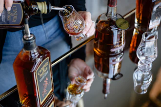 An employee pours a glass of The Bard's product in what will be a new production area at The Bard Distillery, Graham, Ky., March 9, 2025.