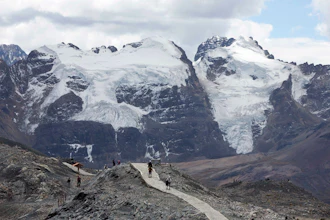 Tourists walk in front of the Tuco glacier in Huascaran National Park, Huaraz, Peru, Aug. 12, 2016.