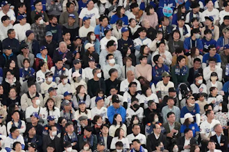 Fans watch the Los Angeles Dodgers play the Chicago Cubs in the first inning of an MLB Japan Series baseball game in Tokyo, March 18, 2025.