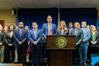 Acting U.S. Attorney Lisa Kirkpatrick, center, speaks during a press conference at the Minneapolis federal courthouse, March 19, 2025.