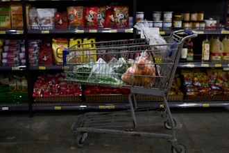 A shopping cart filled with groceries sits in an aisle at an Asian grocery store in Rowland Heights, Calif., Thursday, April 3, 2025.