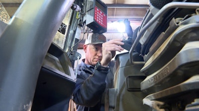 Bryant Kagay, part owner of Kagay farms in Amity, Mo., works on equipment, April 4, 2025.