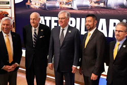 Current, former and incoming Caterpillar CEOs pose for photos on the floor of the New York Stock Exchange, April 15, 2025