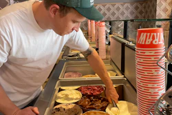 Salt & Straw Ice Cream co-founder Tyler Malek scoops 'Day-Old Bread Pudding' ice cream in Los Gatos, Calif., June 2, 2023.