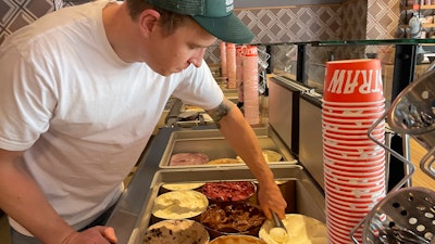 Salt & Straw Ice Cream co-founder Tyler Malek scoops 'Day-Old Bread Pudding' ice cream in Los Gatos, Calif., June 2, 2023.