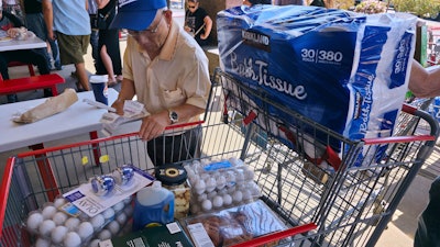 A customer checks his receipts at a Costco Wholesale store in Glendale, Calif., April 10, 2025.