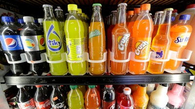 Soft drink and soda bottles are on display in a refrigerator at El Ahorro market in San Francisco, Sept. 21, 2016.