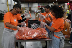 Volunteers pack produce at the Alameda County Community Food Bank in Alameda, Calif., April 25, 2025.