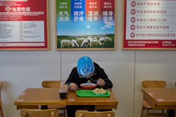 Liu Lijie, a food delivery rider from Ele.me, eats a meal at Yushiji restaurant, Beijing, March 18, 2025.
