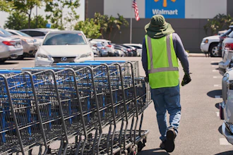 Empty shopping carts are collected from the parking lot at Walmart store in Burbank, Calif., on Thursday, April 10, 2025.