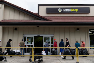 People wait in line outside the Glisan BottleDrop Redemption Center on Thursday, May 15, 2025, in Portland, Ore.