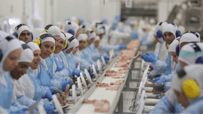 Workers prep poultry at the meatpacking company JBS, in Lapa, in the Brazilian state of Parana, March 21, 2017.