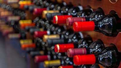 Multiple wine bottles on bottle racks.