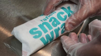 Wayne Kuhl, a McDonald's chef, wraps a snack wrap at McDonald's Headquarter in Chicago, May 29, 2025.