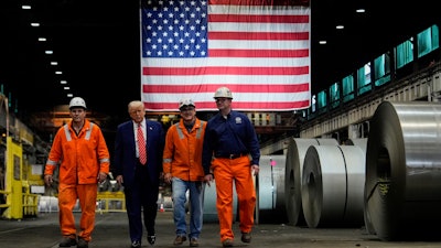 President Donald Trump walks with workers as he tours U.S. Steel Corporation's Mon Valley Works-Irvin plant, Friday, May 30, 2025, in West Mifflin, Pa.