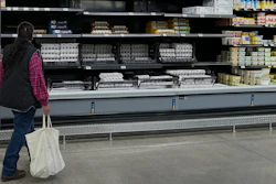 A shopper passes by the display of cartons of eggs in a Walmart store, Feb. 7, 2025, Englewood, Colo.