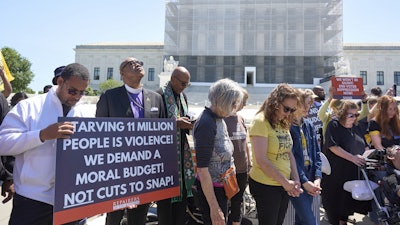 Activists with the Poor People's Campaign protest against spending reductions outside the Supreme Court, June 2, 2025.