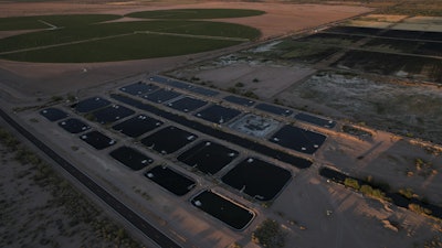 Artificial ponds for farmed fish operate near crop fields Saturday, April 19, 2025, at a Mainstream USA fish farm in Dateland, Ariz.