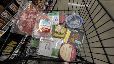 An assortment of vegan, organic, locally sourced and wild caught food products sit in a shopping cart at a grocery store in New Orleans, Wednesday, April 17, 2024.