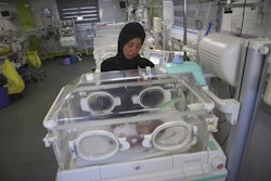 Seham Fawzy Khodeir watches her son, Hisham, in an incubator at the neonatal intensive care unit of Nasser Hospital, Khan Younis, southern Gaza Strip, June 19, 2025.