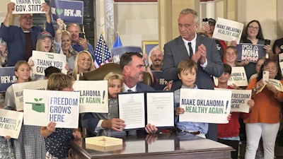 U.S. Secretary of Health and Human Services Robert F. Kennedy Jr. applauds after Oklahoma Gov. Kevin Stitt signs an executive order, Oklahoma City, June 26, 2025.