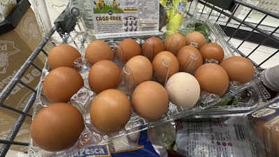 Eggs sit in a container in a shopping cart at grocery store, Monday, Jan. 27, 2025, in Windham, Maine.