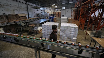 Employees of the Murree Brewery work at a soft drink production unit of the factory, in Rawalpindi, Pakistan, June 23, 2025.
