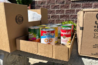 Cans and boxes of food sit on a bench outside the Samaritan Center food pantry in Jefferson City, Mo., July 1, 2025.