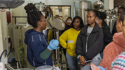 Students prepare to brew beer with South African beer brewing master Apiwe Nxusani-Mawela, in Johannesburg, South Africa, June 5, 2025.