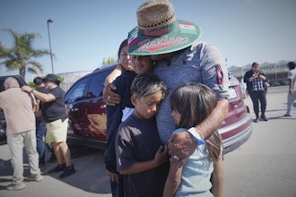 People embrace outside of Glass House Farms, a day after an immigration raid on the facility, on Friday, July 11, 2025, in Camarillo, Calif.