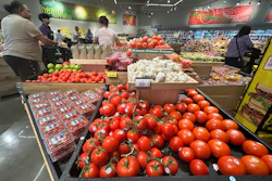 Tomatoes are displayed as customers shop at a grocery store in Glenview, Ill., Tuesday, July 15, 2025.
