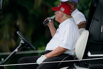 President Donald Trump drinks a Diet Coke during the ProAm of the LIV Golf Team Championship at Trump National Doral Golf Club, Oct. 27, 2022, Doral, Fla.