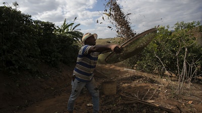 Coffee producer Jose Natal da Silva sifts coffee beans on his farm in Porciuncula, Rio de Janeiro state, Brazil, Thursday, July 17, 2025.