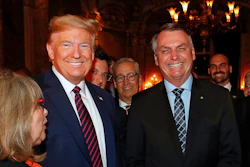Brazil's President Jair Bolsonaro, right, stands with President Donald Trump during a dinner at Mar-a-Lago, Palm Beach, Fla., March 7, 2020.