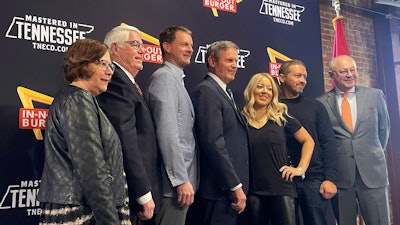 Tennessee Gov. Bill Lee, center, poses with In-N-Out Burger owner and President Lynsi Snyder, to his right, Franklin, Tenn., Jan. 10, 2023.