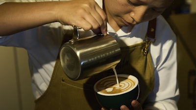 An employees pours coffee for a customer at Himalayan Java cafe at Boudhanath Stupa in Kathmandu, Nepal, Tuesday, June 10, 2025.